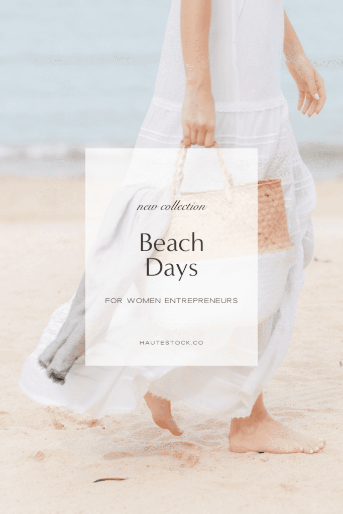 Beach stock image featuring woman on beach walking on the sand in white dress and holding beach bag.