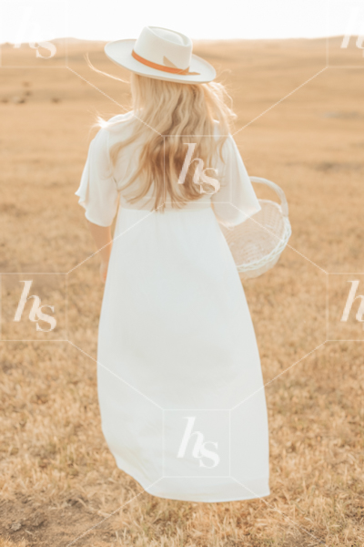 Autumn Lifestyle Stock photo of a blonde woman wearing a vintage white dress in a field