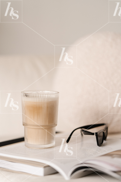Aesthetic stock image featuring cup of coffee, book and sunglasses.