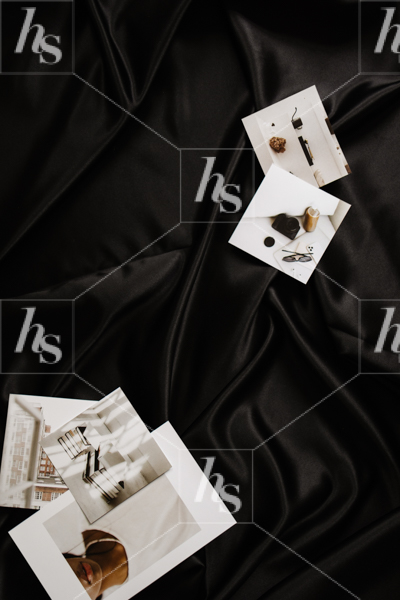 Stock image of a creative workspace flatlay featuring poloroids of photographs.