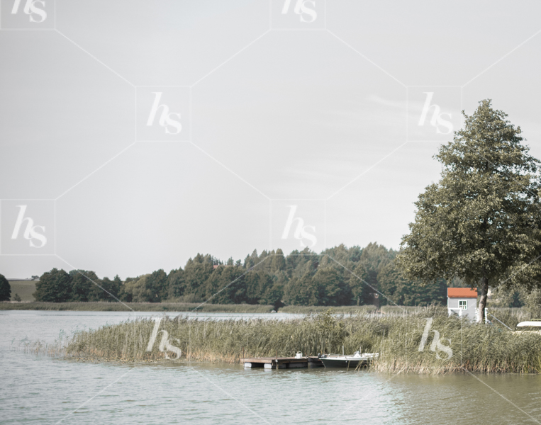 Snapshot of a lake and cottage, calming and refreshing landscape by Haute Stock in our Calming Stock Photos & Videos