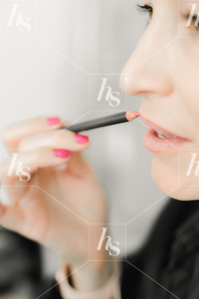 Woman applying lip pencil by Haute Stock Beauty Stock Photography