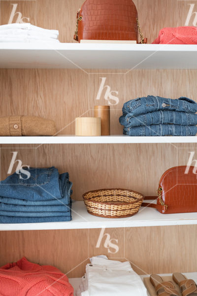 Stock image of store shelf featuring clothing and accessories.