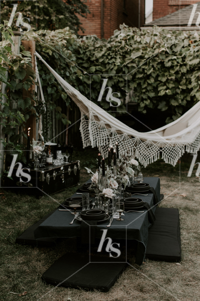 Black and moody table setting for a Halloween theme party.