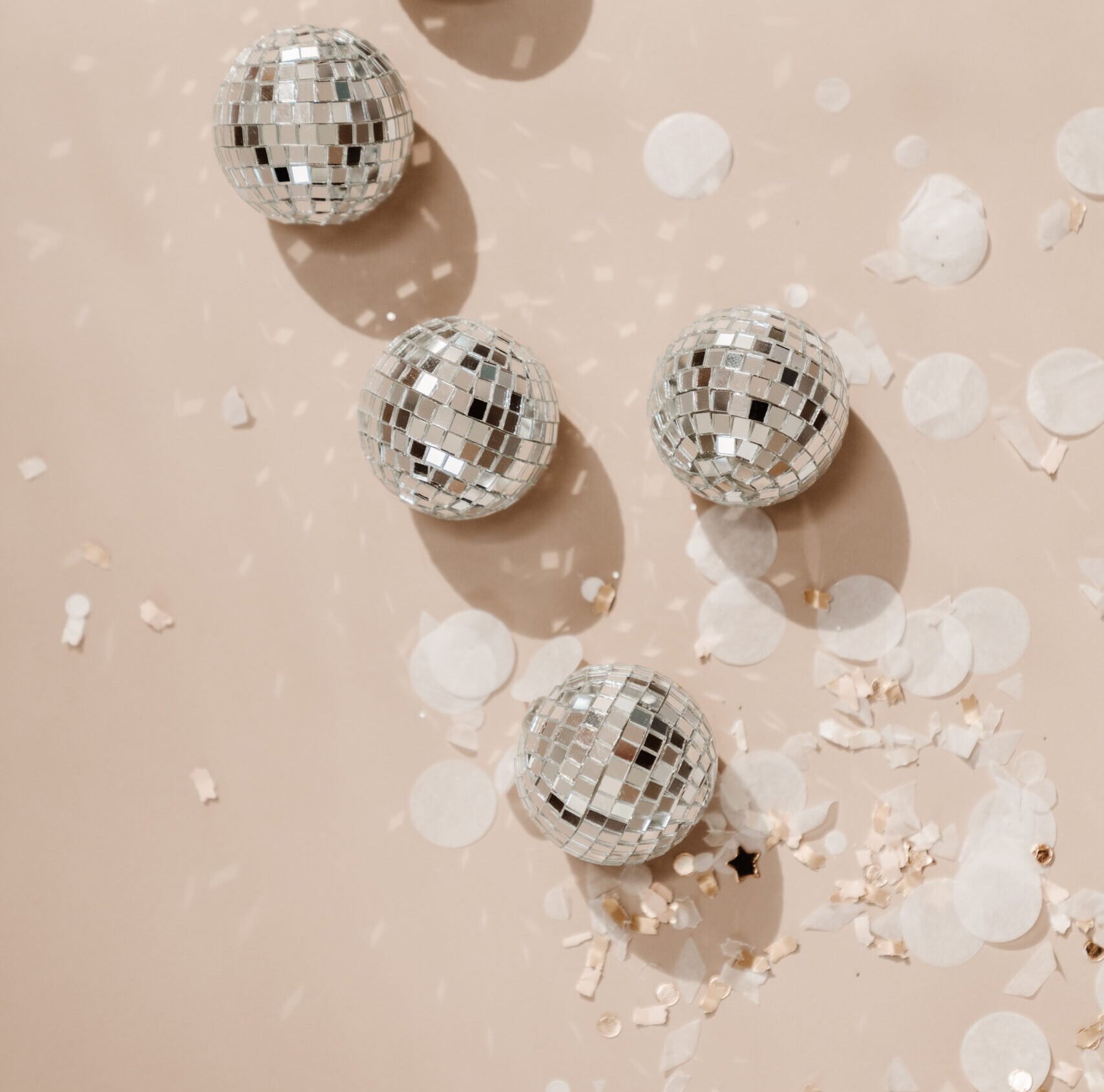 Stock image by Haute Stock featuring mini disco balls flatlay with confetti on taupe background
