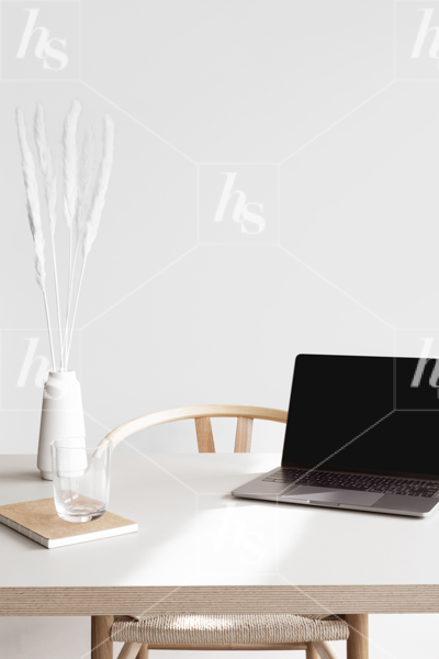 White modern workspace with blank laptop screen, white vase and notebook. Stock photography for mockups