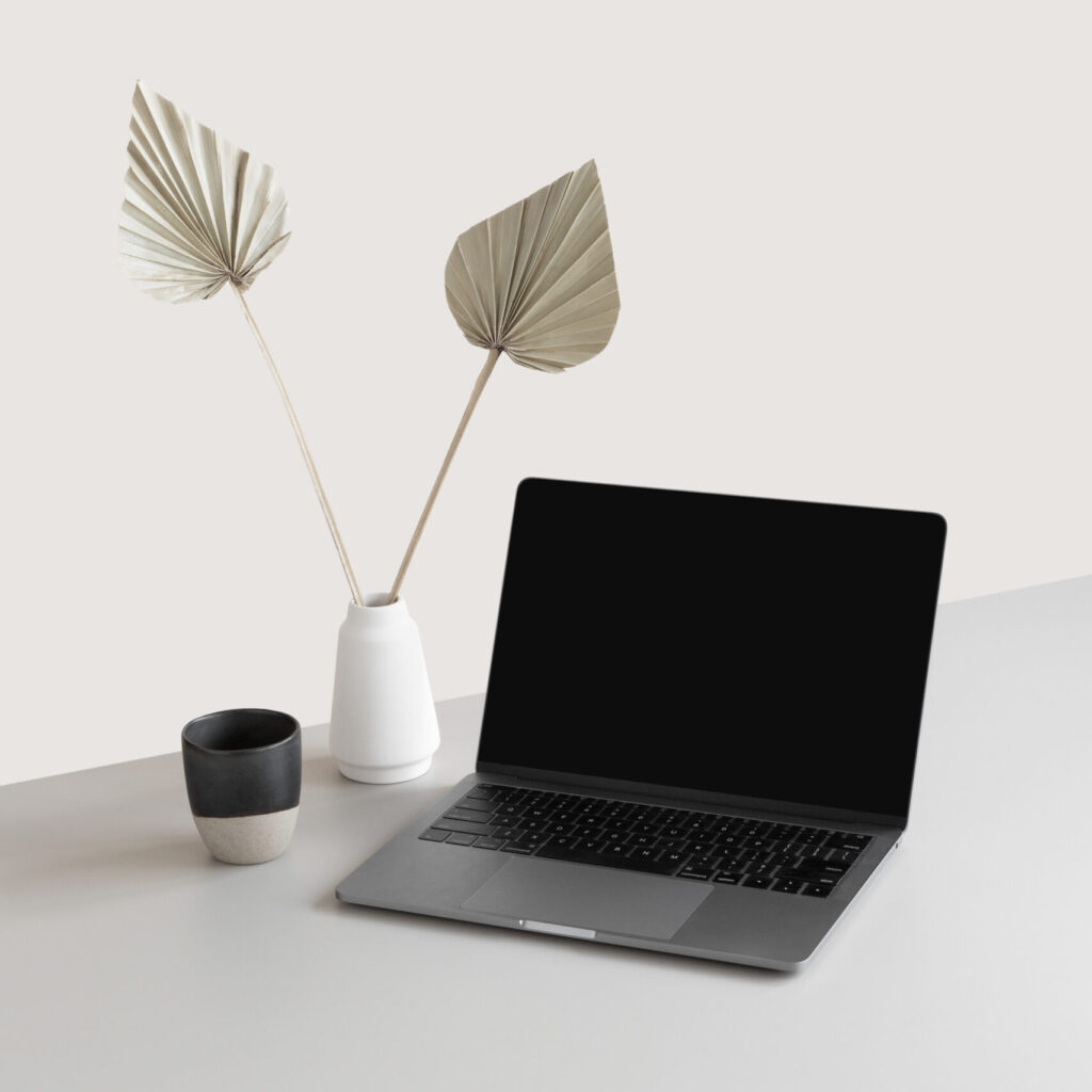 Stock Photo of a laptop mockup, coffee mug and a white vase on desk, part of the Mockups Collection by Haute Stock in Collaboration with Moyo Studio