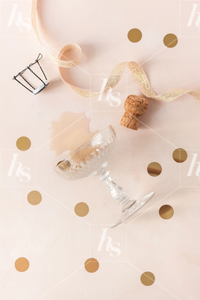 Flatlay of champagne glass, ribbons and cork as part of holiday celebration photo collection
