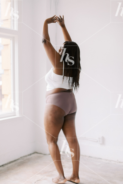Stock image of plus size African American woman stretching perfect for wellness bloggers