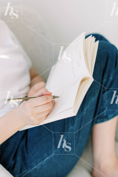 Stock photo of woman writing in her journal