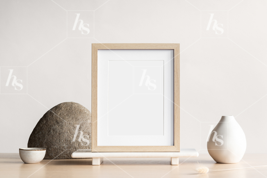 Styled stock photo of a simple wood frame mockup on neutral table perfect to display your designs and brands.