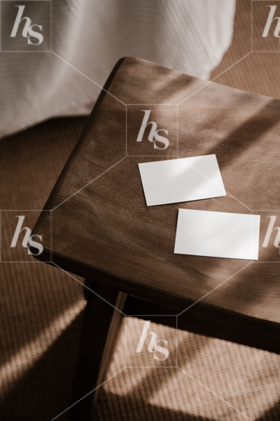 Styled photo of card mockups on curved stool for designers in brown color palette. Minimalist Mockups and Flat Lays