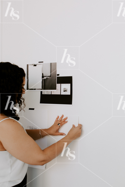 woman pinning inspiration to the wall in fashion stock photos collection by Haute Stock