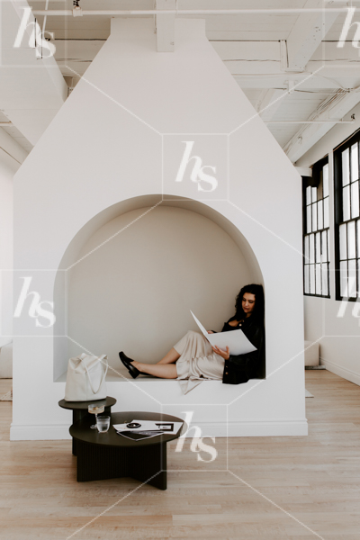 Workspace stock photo of woman reading in white arched nook