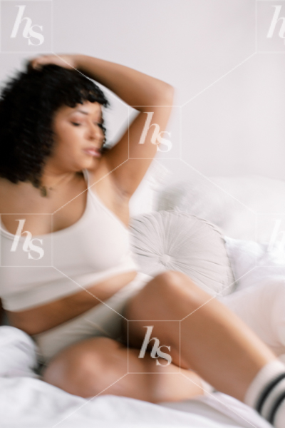 Body positivity styled stock image featuring a plus size woman on bed