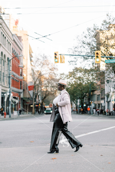 Stock image of woman crossing the street, perfect for fashion and lifestyle bloggers