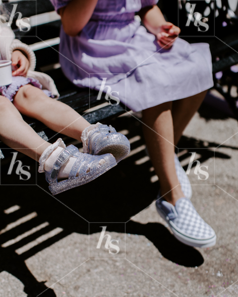 Children enjoying in=ce cream while sitting on a bench, motherhood stock images by Haute Stock.