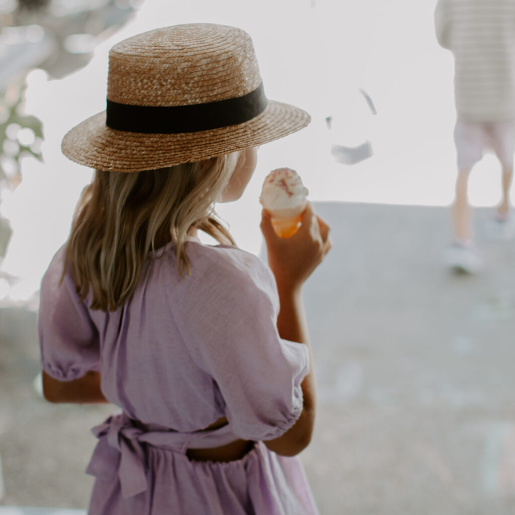 Ice Cream Stock image of a girl in purple dress and straw hat having ice cream in the summer