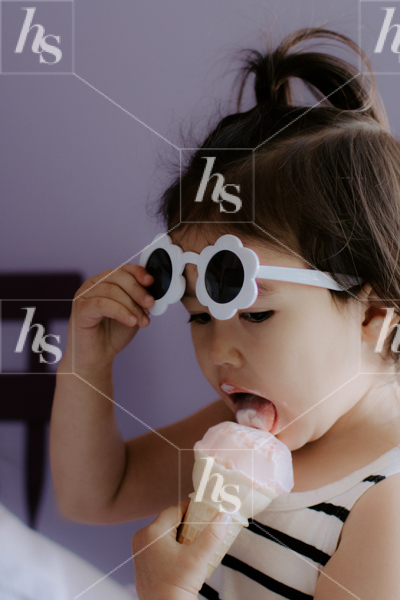 A little girl enjoying an ice cream cone, part of Haute Stock's Ice Cream Stock Photos collection.
