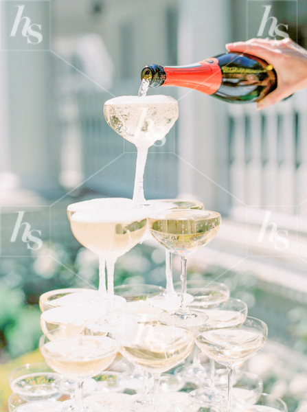 Stock photo of woman Pouring a champagne tower, perfect of event planners