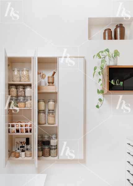 Styled stock photo of nicely organized pantry with glass jars