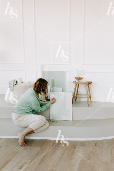 Woman prepping her painting, a stock photo part of Haute stock's Hint of Mint collection