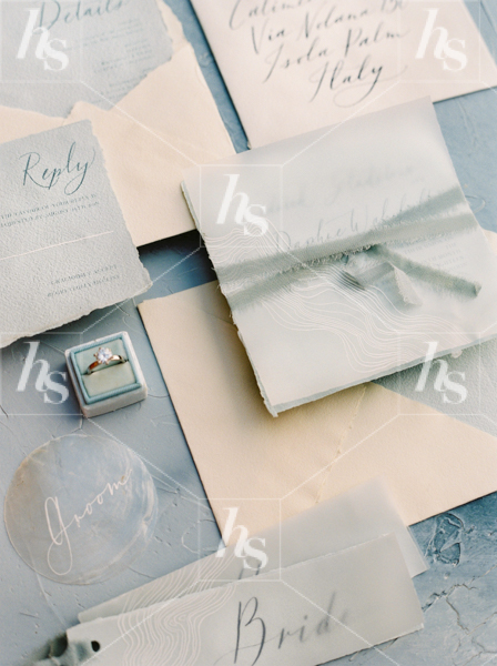 Stock image of blue wedding invitation suite and diamond ring