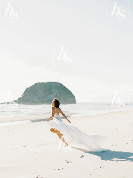 Beautiful stock image of a bride running on a sandy beach, part of Haute Stock's latest collection Something Blue