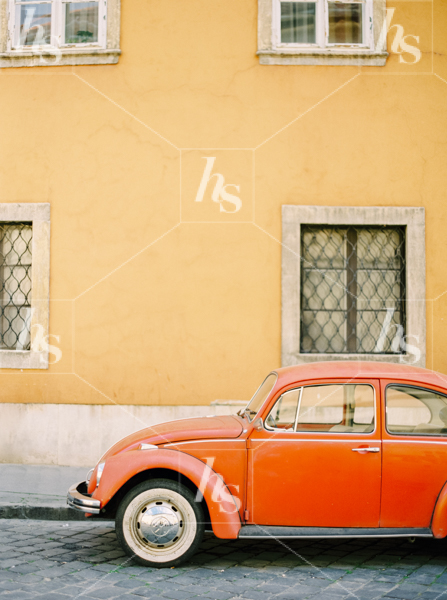 Red vintage car parked on street of Italy, a great stock image part of Haute Stock Getaway collection