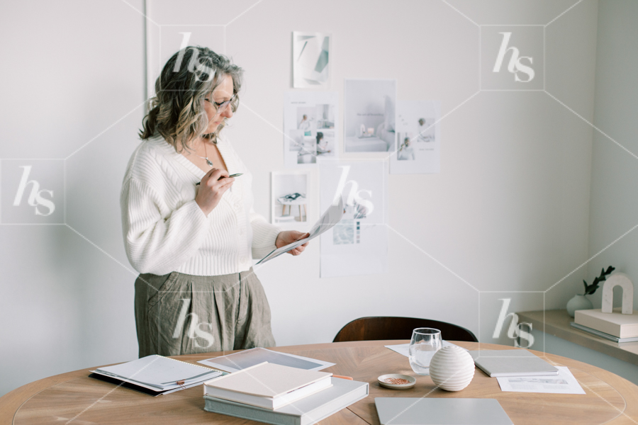Mature woman reviewing paperwork at her desk. Perfect stock image for woman entrepreneurs.