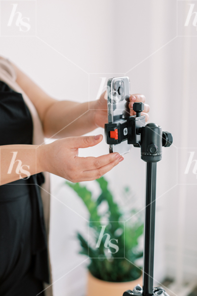 Woman setting up camera for recording, A perfect stock image for content creators, educators and business coaches.