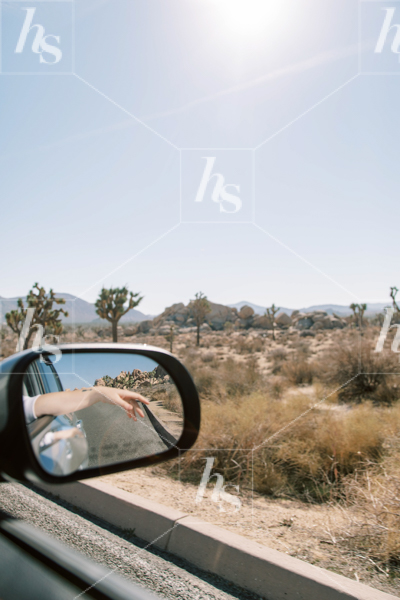Woman driving down desert path, a stock photo for adventurers out there.