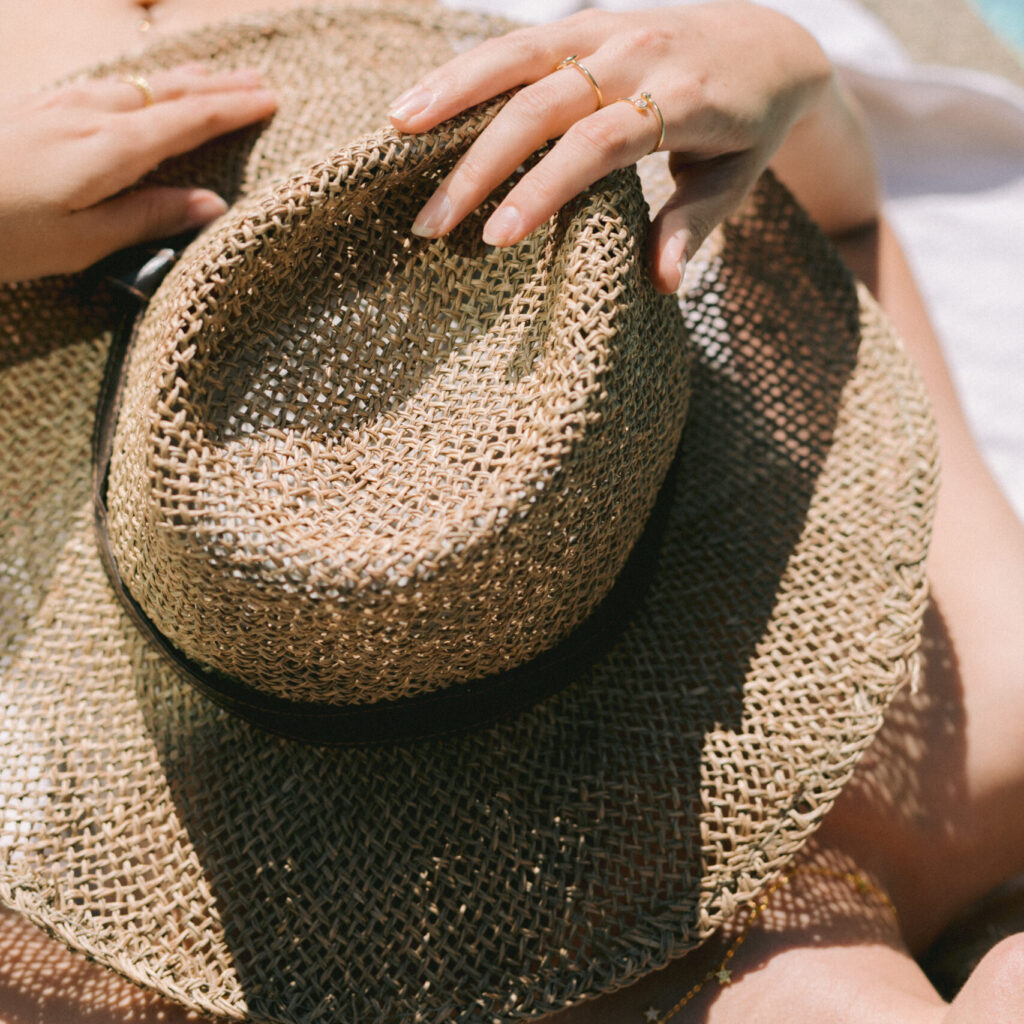 Stock photo of woman sunbathing with straw hat in her hand, perfect image for your seasonal graphics.