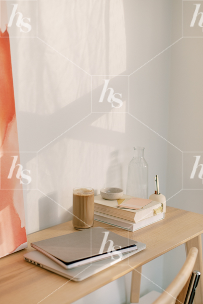 A desk with laptop, coffee and books. Browse the full collection of stock photos for Creative Designers.