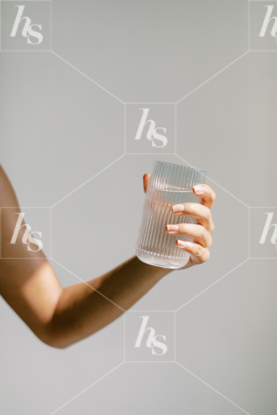 Wellness stock image featuring a woman holding a glass of water.