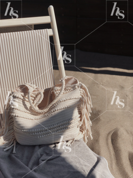 Moody stock photo of beach bag and sun chair under the tuscan sun
