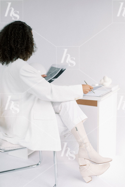 A woman in a white suit reading a document in this collection of Editorial Workspace Stock Videos & photos.