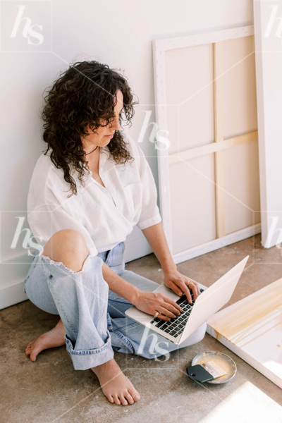 Woman working on laptop while in studio, premium image for creative entrepreneurs. preview the entire Artwork collection.