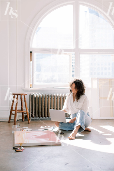 Woman using laptop at art studio, premium stock photo for creatives and designers