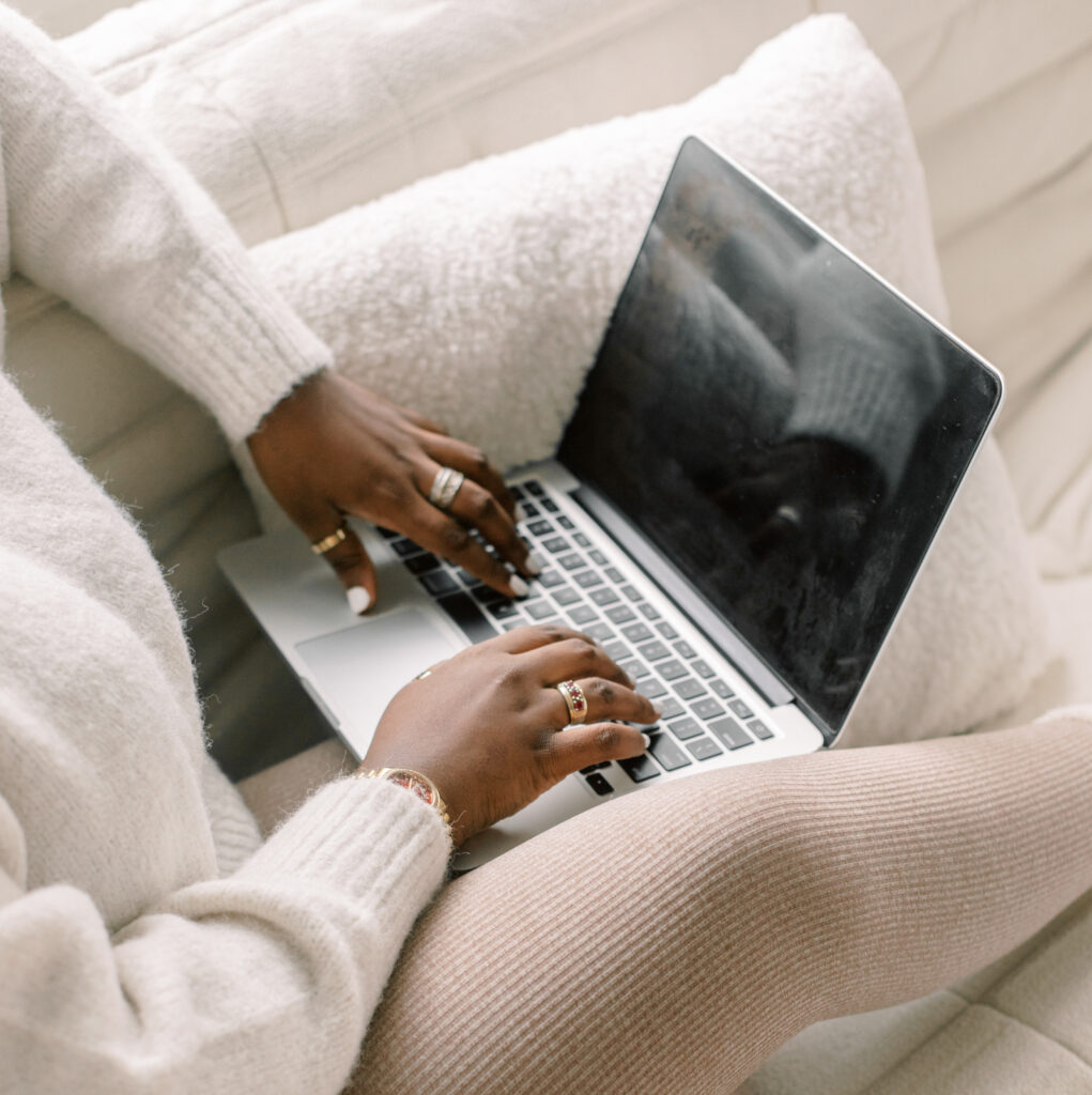 Woman working from home, sitting all cozy on couch while typing on laptop. Part of Winter Nights, workspace stock photos & videos collection.