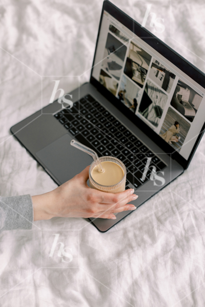 Woman drinking coffee and working from bed, part of a cool workspace stock photos & videos collection, perfect for creatives 