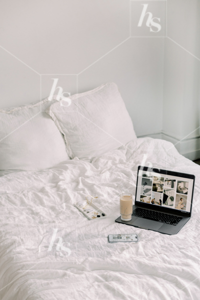 Work day from bed: laptop, coffee, phone, and other accessories, part of cool workspace stock photos and videos collection perfect for chill and creative entrepreneurs