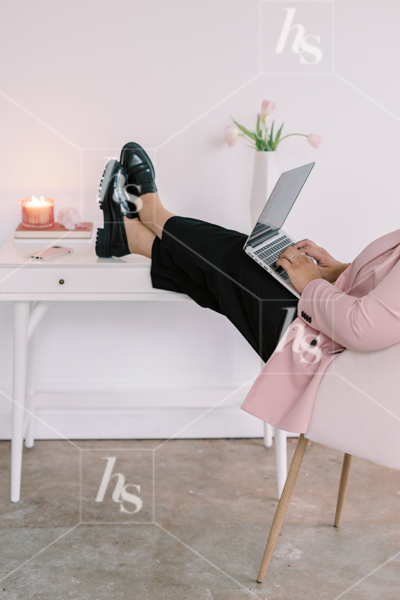 Woman lounging at desk while typing on laptop, part of Millennial pink: feminine workspace stock videos collection.