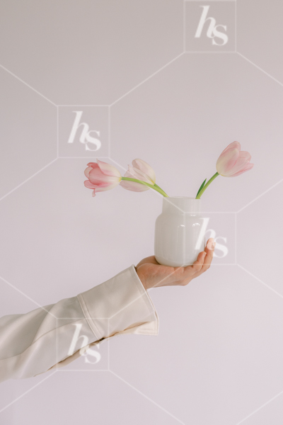 Woman holding vase of tulips, part of Millennial pink: feminine workspace stock videos collection.