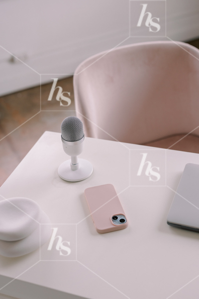 Podcast and phone on desk, part of Millennial pink: feminine workspace stock videos collection.