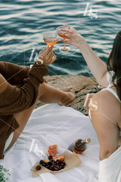 Women toasting to their friendship while relaxing at the beach, part of Sips at Sunset a fun stock photos & videos collection by Haute Stock