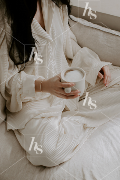 Woman relaxing in PJ lounge set with a latte, part of Lounge, the cozy Retreat, lifestyle stock photos & videos collection