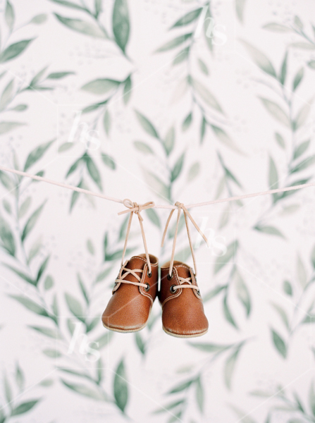 Vintage brown baby shoes hanging from clothing line, part of Nursery baby stock photos collection