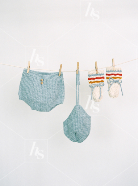 Vintage blue knit baby clothing hanging from clothing line, part of Nursery baby stock photos collection