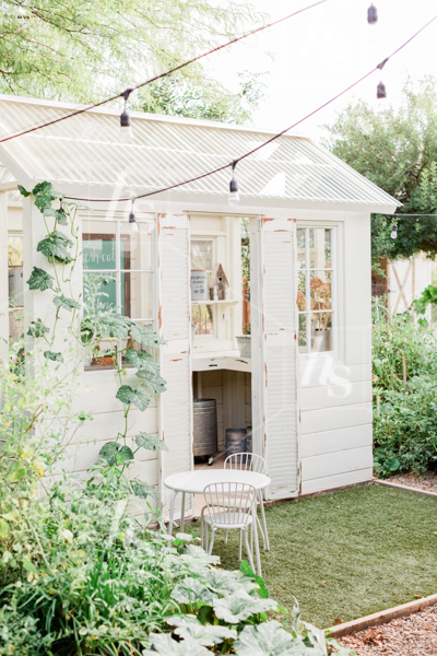 Pulled back shot of rustic greenhouse and bountiful garden, part of  rustic spring stock images collection